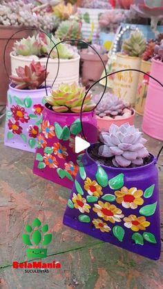 several small pots with flowers painted on them