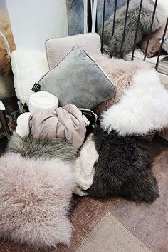 a pile of fur sitting on top of a wooden floor next to a metal cage