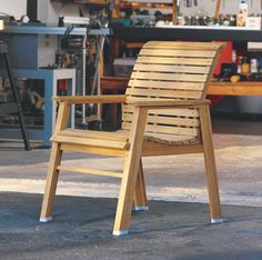 a wooden chair sitting on top of a cement floor