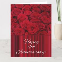 happy 70th anniversary card with red roses in the center and white writing on it's side