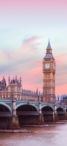 the big ben clock tower towering over the city of london, england at sunset or dawn