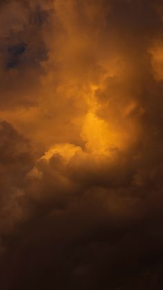 an airplane is flying in the cloudy sky