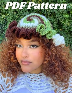 a woman with curly hair wearing a crocheted hat