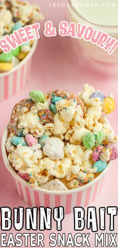 a bowl filled with candy corn and sprinkles on top of a pink table