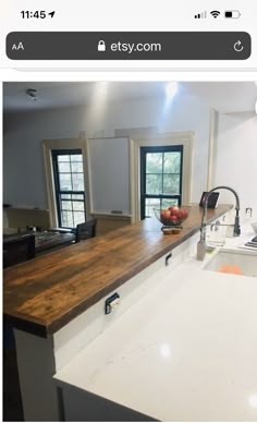 a kitchen counter with a bowl of fruit sitting on it's side next to a sink