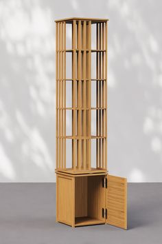 a tall wooden bookcase sitting next to a small cabinet on top of a table