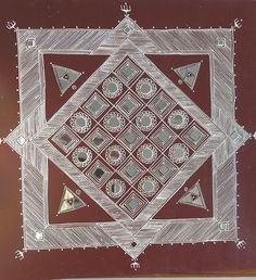 a drawing of a square with triangles and other shapes on it, sitting on top of a wooden table