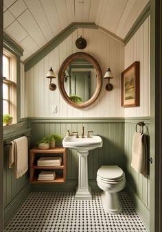 a white toilet sitting next to a sink in a bathroom under a round mirror on the wall