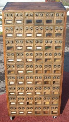 an old wooden filing cabinet with many drawers