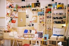 a room filled with lots of clutter and shelves full of items on top of it