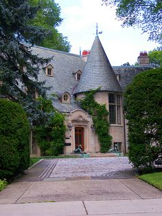 an old castle like building with a clock on it's front door and windows