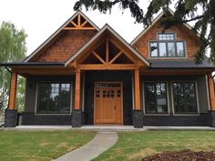 a large house with wood trimming and windows on the front door is shown in this image