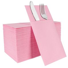 a stack of pink napkins with forks and knives on top of each folded paper