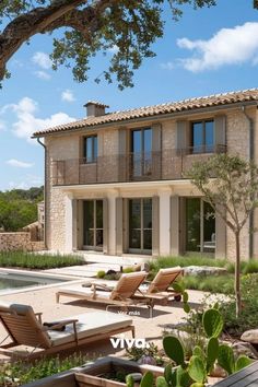 an outdoor patio with chaise lounges and potted plants in the foreground