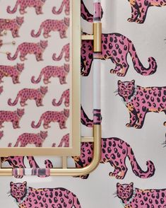 a pink and black leopard print wallpaper with gold frame on it's side