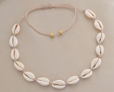 Natural Sea Shells, Cowrie Shell Necklace, Conch Necklace, Boho Jewelry Wonderful summer necklace made of natural shells that are passed on a cord and is a must have of your summer jewelry collection! It's the ideal piece for a summer boho look! Wear it alone or stack it with your other jewelry! Makes the perfect gift for your self, for a beach wedding, for your loved ones! It's adjustable to fit you easily. Handmade necklace with 100% natural sea shells and mackrame closure. Choose your favorite color cord from the drop down menu! Product Details: * Made to order * Nylon Waxed Cord * 100% natural shells in white/off white/ cream color. * Gold Plated beads  * Macrame closure * The necklace is adjustable 85-90 cm full opened. * Shell sizes may vary due to the natural nature of the item * Pa Cowrie Shell Jewelry, Cowrie Shell Necklace, Beachy Jewelry, Shell Choker, Pola Gelang, Gold Armband, Seashell Jewelry, Jewelry Accessories Ideas, Seashell Necklace