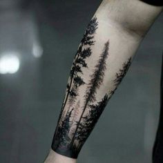 a man's arm with trees on it