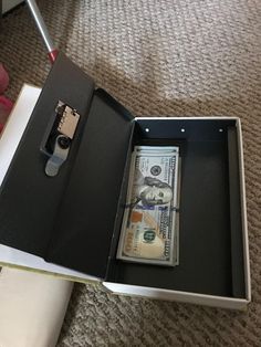 an open briefcase with money in it on the floor