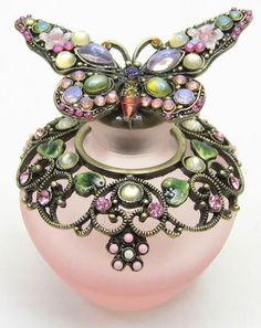 a pink vase with an intricate design on the top and sides, decorated with multicolored stones