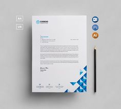 a letterhead with blue triangles and a pencil next to it on a gray surface