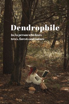 a woman sitting in the woods reading a book