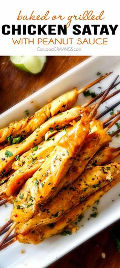 chicken skewers with dipping sauce on a white plate