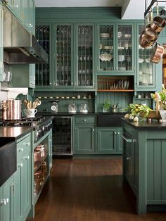 a kitchen with green cabinets and wooden floors is featured on the instagram for an article