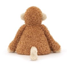 a brown teddy bear sitting on top of a white floor