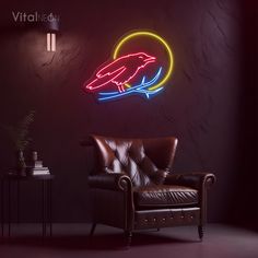 a living room with a leather chair and neon sign