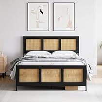 the bed is made with rattan panels and wicker headboard, along with two pictures on the wall above it