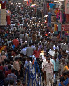 a large crowd of people walking down a street