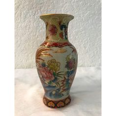 an ornate vase with flowers painted on it