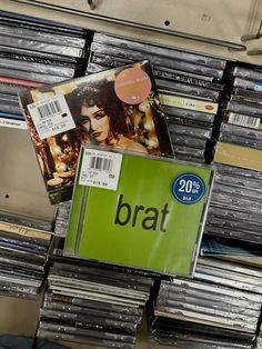 cd's are stacked on top of each other in a store display case for sale