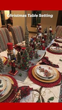 a christmas table setting with plates and place settings