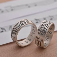 two wedding rings with musical notes on them