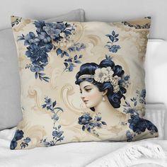 a decorative pillow with blue flowers and a woman's face on the back of it