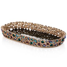 a gold bracelet with multicolored stones and filigrees on the sides