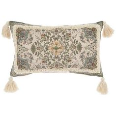 an embroidered pillow with tassels on it