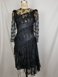 Good vintage condition Black lace Lace slip underneath 34 bust 32 waist 38 hip Has some stretch Sleeve 24 15 shoulders Fitted Lace Patchwork Evening Dress, Fitted Lace Patchwork Dress For Evening, Fitted Scalloped Lace Evening Dress, Fitted Lace Evening Dress With Scalloped Detail, Fitted Lace Evening Dress With Scalloped Lace, Fitted Lace Dress With Lace Trim For Night Out, Fitted Lace Dress With Lace Patchwork For Evening, Black Fitted Lace Evening Dress, Black Fitted Lace Dress For Evening