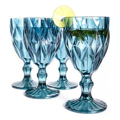 three blue glass goblets with lemon wedges