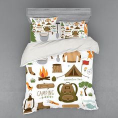 a bed with camping themed sheets and pillows