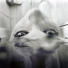 a woman's face with the words just remember above her eyes and in the water