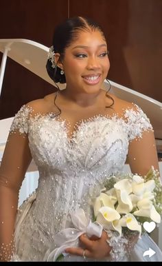 a woman in a wedding dress standing next to a piano and holding a bouquet of flowers