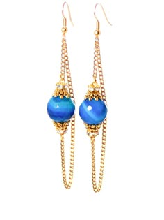 pair of earrings with blue beads and gold chains on the ear hooks, isolated against a white background