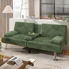 a green couch sitting in a living room next to a window