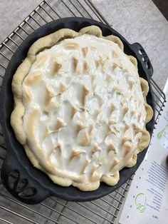 an uncooked pie sitting on top of a cooling rack