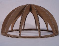 a paper model of a wooden structure on a white background