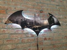 the dark knight batman symbol on a brick wall