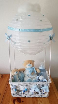 a basket filled with baby items on top of a wooden table next to a wall