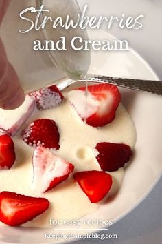 strawberries and cream is being poured into a bowl